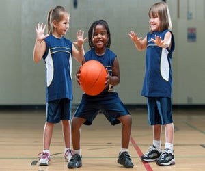 Kids playing basketball. Photo courtesy Canva