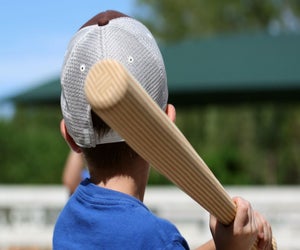 Swing for the fences at summer sports camps. Photo courtesy of Canva