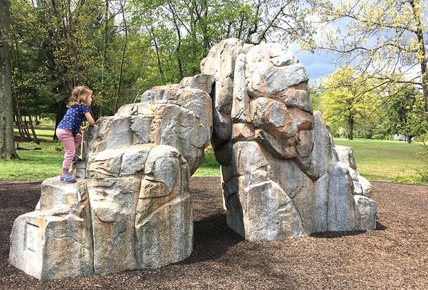 Girl climbs rock formation at Watchung Reservation