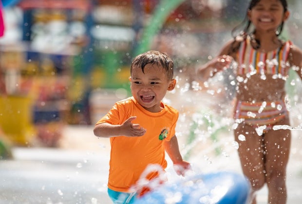 little boy plays at the water playground at Splish Splash Water Park in New York