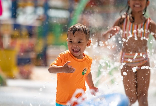 little boy plays at the water playground at Splish Splash Water Park in New York