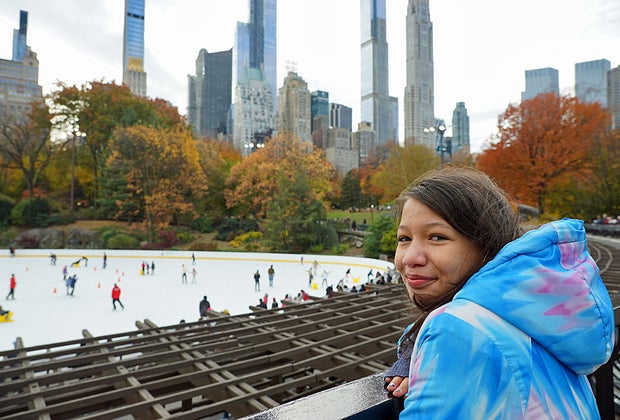 View overlooking Wollman Rink with NYC skyline behind it.