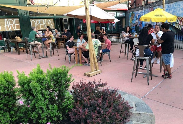 people dining on the patio at yonkers brewing company