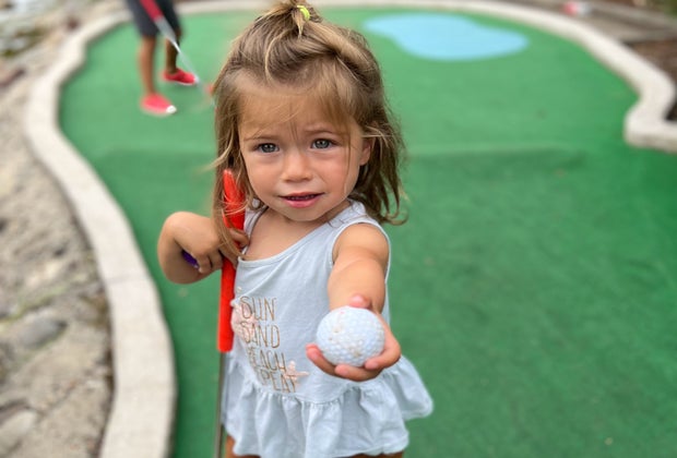 Photo of young child with a golf ball - Best Mini Golf Courses in CT