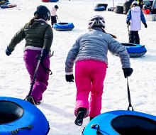 Get those snow pants ready for the best snow tubing in Connecticut for families! Photo by Ally Noel for Mommy Poppins