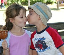 Two kids share a caramel apple. Photo by Meghan Rose