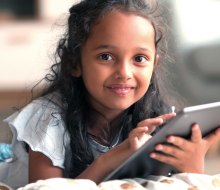 Go ahead. Hand them the iPad; these websites for kids are fun and at least a little educational. Photo courtesy of Bigstock