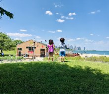 Two little Chicagoans, fresh from the splash pad at 31st Street Harbor, contemplate going to the beach. 