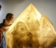 Visitors are allowed to touch the massive amber-colored crystal from Namibia at the Yale Peabody Museum. Photo by Robert Lorenz .