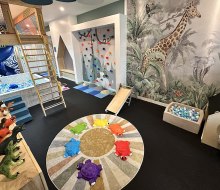 Good Life Clubhaus' play space includes a ball pit, climbing structures, sensory floor tiles, and a small netted clubhouse. Photo by the author