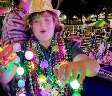 <i>Kids absolutely love catching Mardi Gras beads.</i>