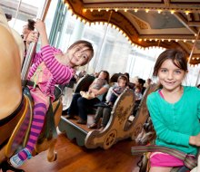 NYC park attractions, like Jane's Carousel in Brooklyn Bride Park, make great, budget-friendly spots to host a birthday party. Photo courtesy of the carousel