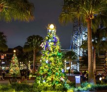 The holidays have arrived at Disney Springs! Stroll through the Tree Trail and nightly snow flurries for free. Photo courtesy of Disney