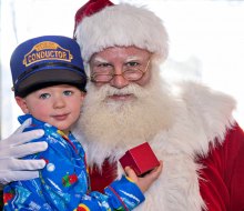 Santa brings holiday cheer (and a special gift) to each of his  young passengers. Photo by Robert Berard courtesy of Blackstone Valley Tourism Council