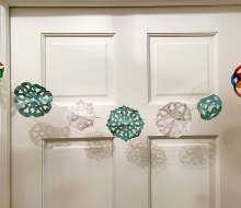 Making paper snowflakes from recycled wrapping paper is easy and fun for kids. Photo by the author