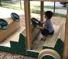 Little ones can take the wheel(s) of the wooden car at Sunset Park.