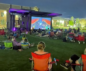 Everyone is invited to the Crabapple Market Green where families enjoy a free, family-friendly movie night. Photo courtesy of Crabapple Market