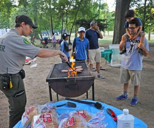 Urban Park Ranger mans the grill at a campout