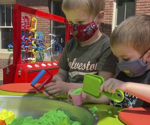 Photo of kids playing on patio of NH Children's Museum.