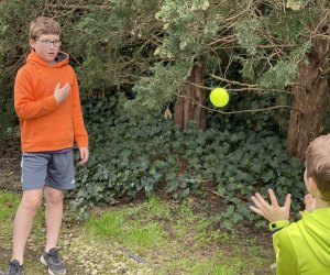 Hiking Games for Kids That Turn Walks into Adventures: kids playing catch with a tennis ball