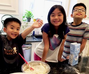 kids at at a counter cooking in the kitchen