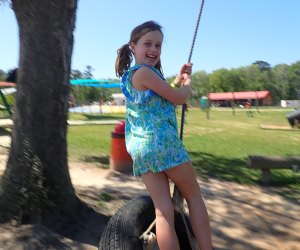 Georgia Peach World Farm girl on a tire swing