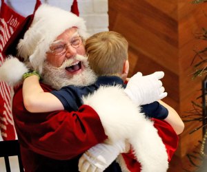 Boy getting a hug from Santa