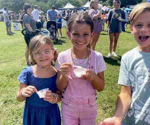 Families sample tons of ice cream flavors, all for a great cause! Visitors to the 20th Annual Miss Mary's Ice Cream Crankin' are treated to locally churned ice cream flavors plus some fun giveaways.  Photo by the author