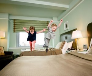 Kids dive on Bed Hotel Beacon