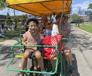 Things to do in NYC this summer: Families ride a surrey on Governors Island