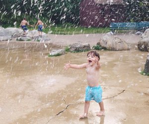 Image of child splashing in Boston sprinkler park.