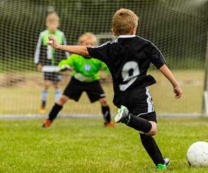 Boy shooting a goal. Photo courtesy Bigstock