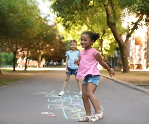 Girls playing hopscotch, can't be bored when you're hopping!