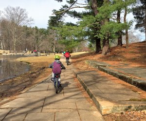 Photo of kids biking along the edge of a pond - stroller-friendly hikes