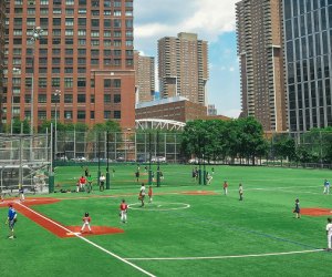 Things to do in Battery Park kids playing baseball