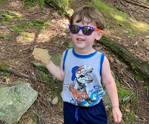 Boy hiking on trail in the woods