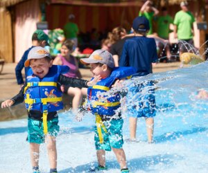 Photo of two kids getting splashed with water- Best Outdoor Water Parks