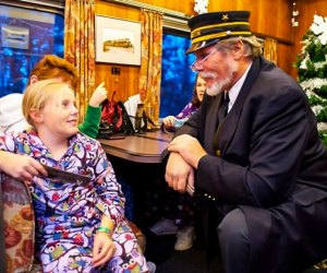 Kids love to don pajamas and hand Christmas train conductors their golden tickets. Photo courtesy of the Cape Cod Central Railroad, Facebook