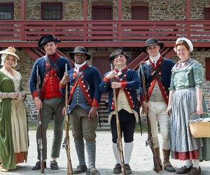 Historical interpreters pose outside The Old Barracks Museum. 