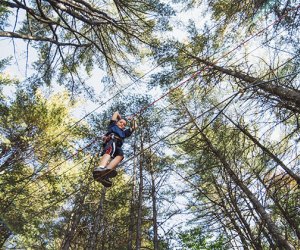 Boy walks across a tight rope at Cape May County Tree to Tree Adventure Park