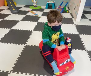 Boy rides kiddie coaster at The Kiddie Clubhouse