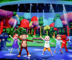 Cocomelon characters on stage during a live performance