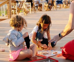 Kids playing scrabble at Collective Givernors Island