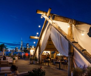 Collective Governors Island at night with NYC skyline in background