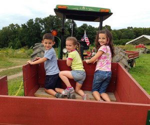 Image of kids playing at an apple orchard near Boston.