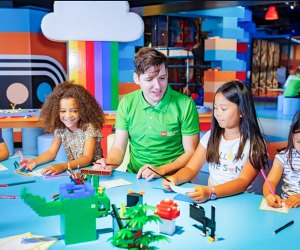 Image of people building with LEGOs at LEGO Discovery Center Boston.