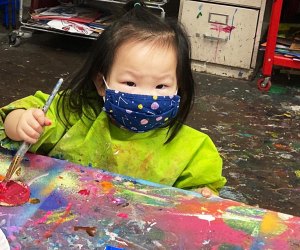 chlld creating art at Creative Wild Art Studio.