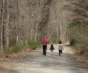 kids and dad hike along a trail in the woods at Croton Gorge Park