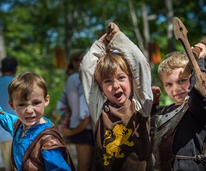 New York Renaissance Faire boys in renaissance clothing holding swords