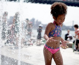 The splash pad in Domino Park puts a smile on faces young and old. Photo by Jody Mercier